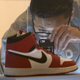 A visitor photographs an Air Jordan I during a preview for "The Rise of the Sneaker Culture" exhibit at the Brooklyn Museum in the Brooklyn borough of New York, July 8, 2015.